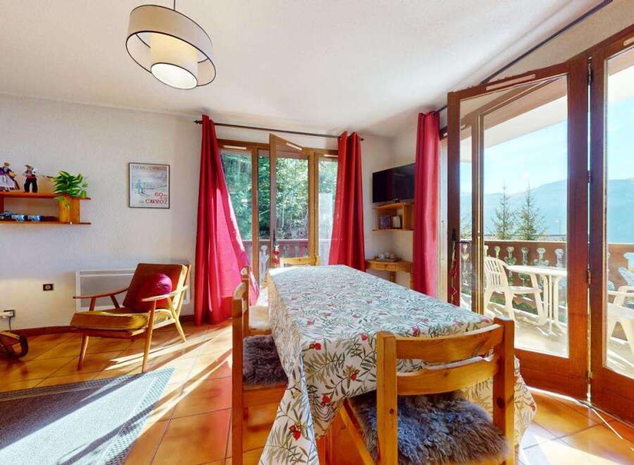 Enjoy breathtaking mountain views from this charming dining area, complete with a large table perfect for family meals.