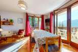 Enjoy breathtaking mountain views from this charming dining area, complete with a large table perfect for family meals.
