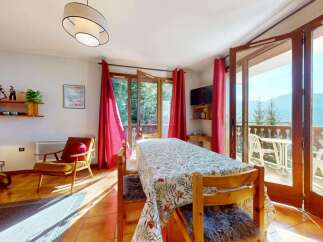 Enjoy breathtaking mountain views from this charming dining area, complete with a large table perfect for family meals.