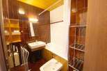 This charming bathroom features a classic white bathtub with a shower curtain, perfect for relaxing after a long day.