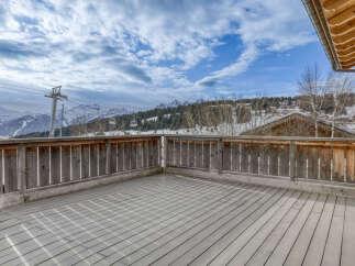 Experience breathtaking mountain views from this spacious wooden deck, perfect for enjoying crisp alpine air.