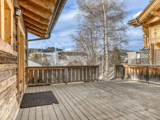 Experience the charm of this rustic wooden cabin, complete with a spacious deck offering breathtaking mountain views.