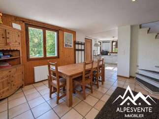 This charming dining area features a rustic wooden table with six chairs, perfect for family meals.