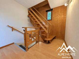Ascend to the upper levels of this charming property via a beautiful wooden staircase, featuring intricate carved detailing on the banister.