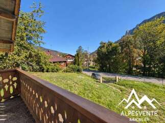 Enjoy breathtaking mountain views from this charming property, featuring a rustic wooden balcony perfect for morning coffee or evening relaxation.