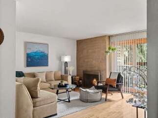 Step into this inviting living room, featuring a cozy fireplace and comfortable seating arrangements perfect for relaxation.