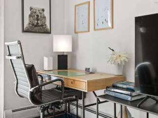This home office features a modern desk with a sleek chair, perfect for productivity.
