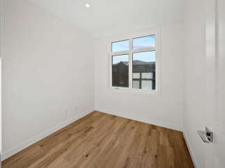 Step into this bright and airy room, featuring a large window that floods the space with natural light.