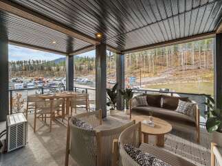Enjoy outdoor living on this spacious covered balcony, perfect for entertaining or relaxing.