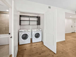 Discover the convenience of an in-unit laundry room featuring two Samsung front-load washers and dryers, perfect for handling large loads.