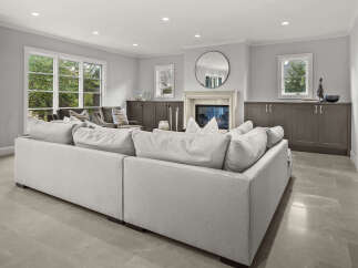 Step into this inviting living room, featuring a plush, light-colored sectional sofa perfect for relaxation.
