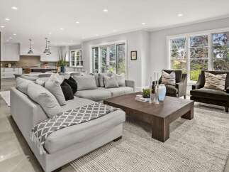 This spacious open-concept living area seamlessly connects to a modern kitchen, perfect for entertaining.