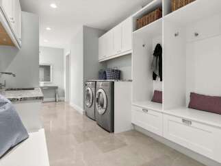 This spacious laundry room and mudroom combo offers ample storage and functionality.