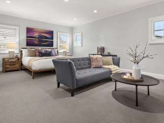 This spacious bedroom offers a serene retreat with a comfortable king-size bed, adorned with plush pillows and a cozy throw.