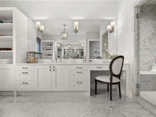 Experience luxury in this stunning bathroom featuring a spacious vanity with ample storage and a built-in makeup area.