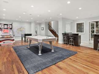 This spacious basement entertainment area is perfect for hosting friends and family.