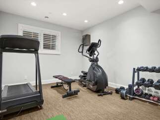 Transform your home into a personal fitness sanctuary with this well-equipped gym space.
