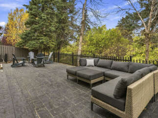 Enjoy outdoor living in this spacious backyard featuring a large stamped concrete patio perfect for entertaining.