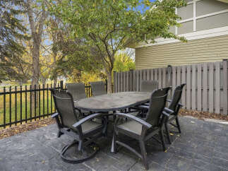 Enjoy outdoor dining on this spacious patio, featuring a large oval table and six comfortable chairs.