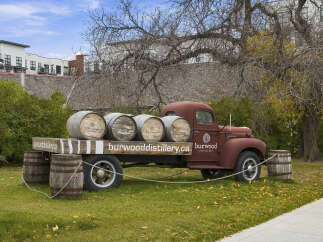 Discover the charm of Burwood Distillery, showcased by this vintage truck adorned with barrels.