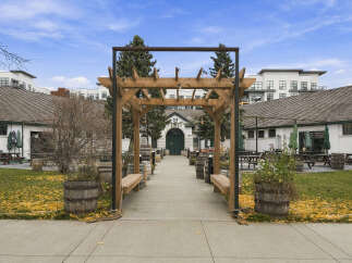 Step into a charming outdoor space featuring a rustic wooden pergola, perfect for creating a welcoming ambiance.