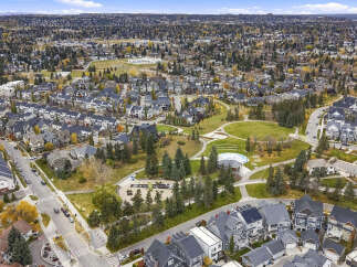 Discover this stunning aerial view of a vibrant suburban neighborhood, showcasing a harmonious blend of modern townhouses and traditional single-family homes.