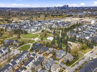 Discover this stunning aerial view of a modern suburban neighborhood, showcasing a harmonious blend of contemporary townhouses and spacious single-family homes.