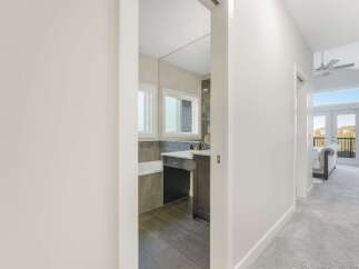 Step into a beautifully appointed bathroom featuring a sleek vanity and a relaxing bathtub, perfect for unwinding.