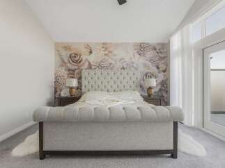 Experience luxury in this master bedroom, featuring a stunning floral wallpaper accent wall that adds a touch of elegance and romance.