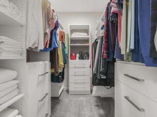 Step into this impeccably organized walk-in closet, designed for ultimate functionality and style.