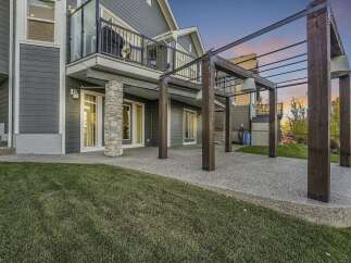 Enjoy outdoor living with this spacious concrete patio, perfect for entertaining guests.