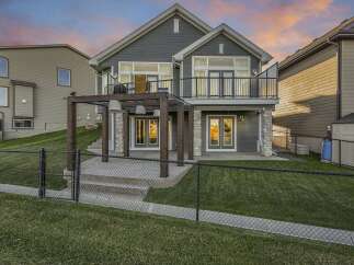 This stunning home features a modern grey exterior with a spacious backyard perfect for entertaining.