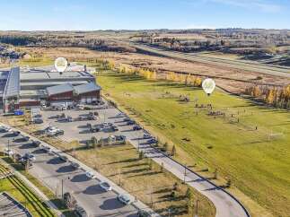 Discover this expansive property featuring a modern commercial building with ample parking and a large adjacent green space perfect for outdoor activities.