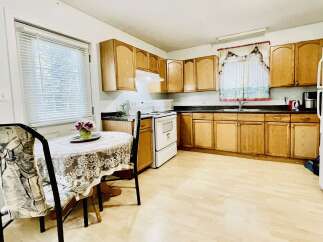 This charming kitchen features warm oak cabinetry, providing ample storage space.