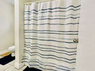 This bathroom features a clean and functional design, with a white toilet visible to the left.