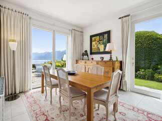 Experience elegant dining with a stunning lake and mountain view from this beautifully appointed dining room.