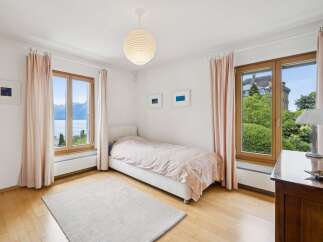Experience serene living in this charming bedroom, featuring a comfortable single bed adorned with a delicate patterned duvet.