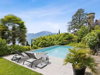 Experience luxurious outdoor living with this stunning infinity pool, offering breathtaking panoramic views of the lake and mountains.