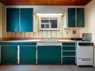 Step into this charming kitchen featuring a double basin sink and a gas range, perfect for home chefs.