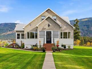Charming home nestled against a backdrop of majestic mountains, offering a serene retreat.