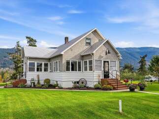 Charming home nestled amidst rolling hills and mature trees, offering a serene retreat.