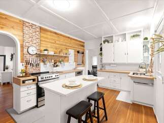 This charming kitchen boasts a rustic brick and wood accent wall, creating a warm and inviting atmosphere.