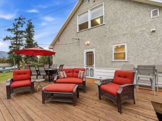 Enjoy outdoor living on this spacious wooden deck, perfect for entertaining or relaxing.