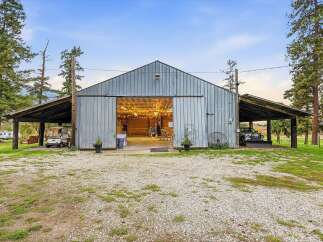 This spacious metal barn offers a versatile open-concept interior, perfect for events or storage.