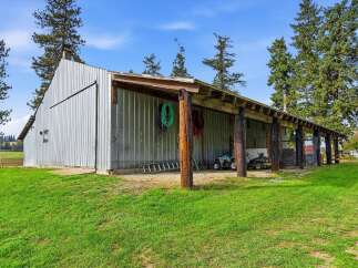 Discover the potential of this expansive metal barn, perfect for agricultural needs or storage.