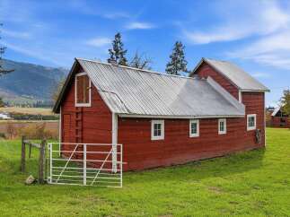 Nestled in a picturesque landscape, this charming red barn offers a rustic retreat.