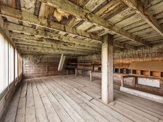 Step into this rustic, unfinished barn interior, offering a blank canvas for your creative vision.