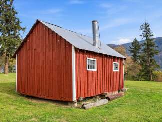 Discover this charming red barn, perfect for a variety of uses.
