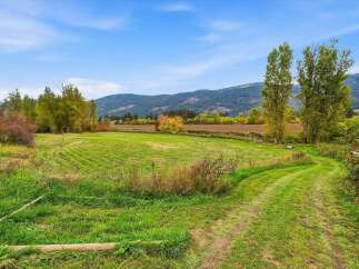 Experience the beauty of rural living with this stunning property featuring expansive green fields and rolling hills.