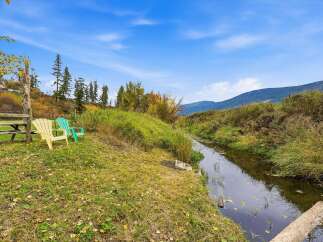 Enjoy the serene beauty of this property, featuring a tranquil stream perfect for peaceful contemplation.